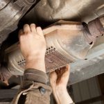 catalytic-converter-removal-at-a-salvage-yard-royalty-free-image-1615767464_