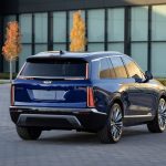 A rear 3/4 view of the 2026 Cadillac VISTIQ in Opulent Blue Metallic.